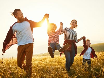 Happy family: mother, father, children son and  daughter on nature  on sunset